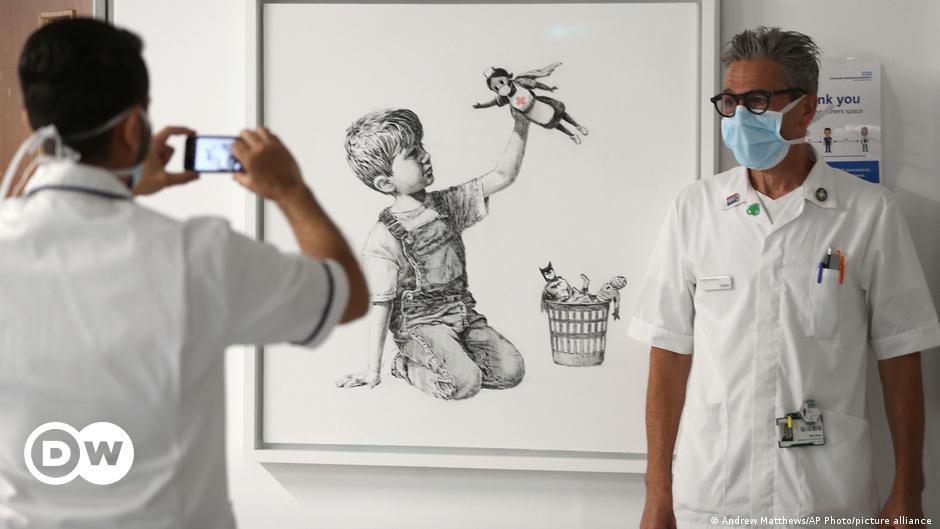 Banksy’s superhero nurse painting sells at record price to fund NHS News DW