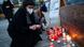 Woman lighting candle at commemoration in Stuttgart Woman lighting candle at commemoration in Stuttgart