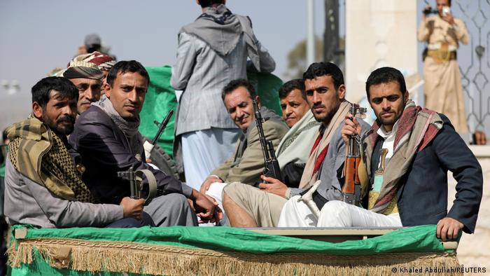 Houthi rebels sit on a truck in Sanaa