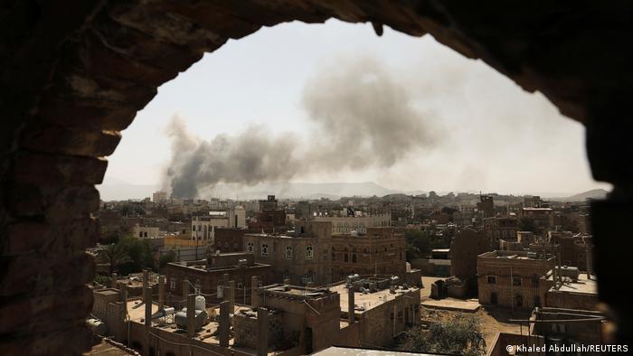 Smoke and dust rise near buildings from air strikes launched by Saudi-led coalition on Sanaa