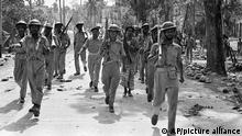 FILE - In this April 2, 1971, file photo, troops of Bangladesh Freedom Army, followers of East Pakistan's Sheikh Mujibur Rahman march off to war against Pakistan Army troops, near Jessore, East Pakistan. Bangladesh is celebrating 50 years of independence this year. (AP Photo, File)