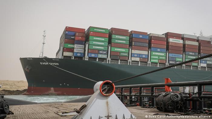 A shot from the bow of a tugboat of it pulling the Ever Given from the banks of the Suez Canal. Stacks containers can be seen on the Ever Given. 