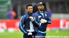 Bangladesh's players Shakib Al Hasan (L) and captain Mashrafe Mortaza walk off the field as rain halts a training session at The County Ground in Taunton, south-west England, on June 16, 2019, ahead of their 2019 World Cup match against West Indies. (Photo by Saeed KHAN / AFP) (Photo credit should read SAEED KHAN/AFP via Getty Images)