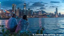 HONG KONG, CHINA - JULY 30: A couple enjoy their moment at a typhoon shelter during sunset in front of Hong Kong skyline on July 30, 2020 in Hong Kong, China. Hong Kong have recorded the highest daily tally of Covid-19 with 149 confirmed cases. (Photo by Anthony Kwan/Getty Images)