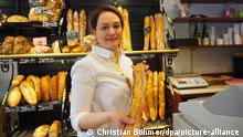 13 April 2018, France, Paris: Lamia M'Seddi of the bakery 2M with a baguette. The bakery won in this year's baguette competition of the city of Paris and can supply the Elysee Palace of President Emmanuel Macron for one year. Photo: Christian Böhmer/dpa