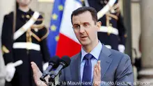 FILE - In this Thursday Dec. 9, 2010 file photo, Syria President Bashar al-Assad addresses reporters following his meeting with French President Nicolas Sarkozy at the Elysee Palace in Paris, France. Paris prosecutors have opened a preliminary investigation into French government accusations that Syrian President Bashar Assad's government has committed crimes against humanity. The prosecutor's office said Wednesday the investigation is based on photos taken by a former Syrian officer who fled in 2013 and focuses on atrocities allegedly committed between 2011 and 2013. (AP Photo/Remy de la Mauviniere, File)