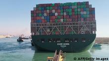 This picture taken on March 29, 2021 from a nearby tugboat in the Suez Canal shows a view of the Panama-flagged MV 'Ever Given' (operated by Taiwan-based Evergreen Marine) container ship as it begins to move. - Egypt's Suez Canal Authority said on March 29 the Ever Given container ship, which has been blocking the crucial waterway for nearly a week, has been turned in the right direction. The position of the ship has been reorientated 80 percent in the right direction, SCA chief Osama Rabie said in a statement. Over 300 ships are currently waiting to travel through the canal. (Photo by - / AFP) (Photo by -/AFP via Getty Images)