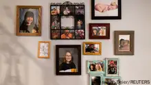 Photos of Stefany Stuber, 40, and her family line the staircase of her home in Philadelphia, Pennsylvania, U.S., March 24, 2021. Picture taken March 24, 2021. Stuber has been talking to her daughter Olivia Metzler, 7, about recent attacks on Asian Americans. REUTERS/Hannah Beier