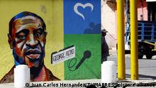 October 26, 2020, Valencia, Carabobo, Venezuela: Caption:October 26, 2020.A man is stopped near graffiti of the Merican, African-descendant George Floyd, who died on May 25, 2020 when a Minneapolis police officer knelt on his neck during an arrest, allegedly for handing over a counterfeit $20 bill. His death provoked multiple protests in major cities in the United States and other countries.This is a tribute by the Mayor of Valencia, to the outstanding afrodescendants . In Valencia, Carabobo, Venezuela - Photo: Juan Carlos Hernandez (Credit Image: © Juan Carlos Hernandez/ZUMA Wire