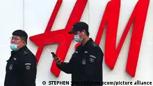 Chinese police walk past H&M's flagship store in Beijing on Thursday, March 25, 2021. The fashion retailer H&M is facing a potential boycott in China, it's fastest growing market, after a statement the company made last year expressing deep concerns over reports of forced labor in Xinjiang stirred a social media storm this week. Photo by Stephen Shaver/UPI Photo via Newscom picture alliance
