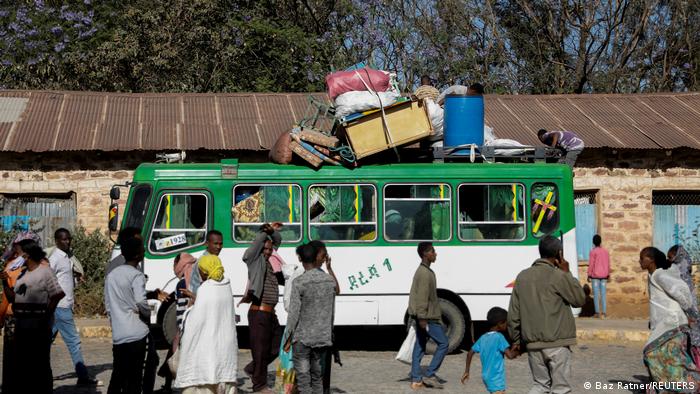 A bus carrying displaced people arrives at the Tsehaye primary school
