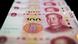 This photo illustration shows Chinese 100 yuan notes in Beijing on January 14, 2020