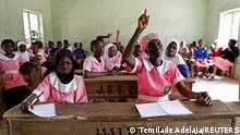 Shade Ajayi, 50, raises her hand to answer a question during class at Ilorin Grammar School in Ilorin, Kwara state, March 25, 2021. REUTERS/Temilade Adelaja SEARCH ADELAJA PUPIL FOR THIS STORY. SEARCH WIDER IMAGE FOR ALL STORIES