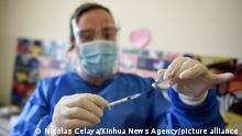 (210302) -- MONTEVIDEO, March 2, 2021 (Xinhua) -- A medical worker prepares to administer China's Sinovac COVID-19 vaccine in Montevideo, Uruguay, March 1, 2021. Uruguay's government on Monday began its immunization campaign against COVID-19 with vaccines developed by Chinese pharmaceutical firm Sinovac, prioritizing teachers, the military and the police. (Photo by Nicolas Celaya/Xinhua)
