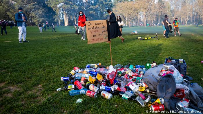 A pile of trash with a sign that reads 'On nous empeche de vivre pour ne pas mourir' (we are prevented from living so as not to die) at the Bois de La Cambre in Brussels, Thursday 01 April 2021. 