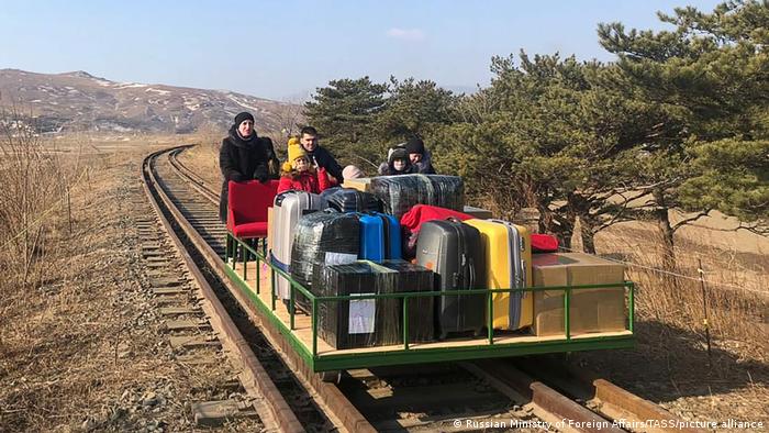 Russian embassy members using a hand-pushed rail trolley to get from North Korea to the Russian border