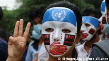 YANGON, MYANMAR - APRIL 04: People, with their masks, stage a demonstration to protest against military coup in Yangon, Myanmar on April 04, 2021. Stringer / Anadolu Agency