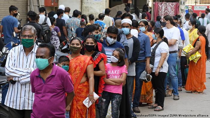 People waiting in a queue outside a Mumbai supermarket on Sunday