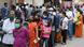 People waiting in a queue outside a Mumbai supermarket on Sunday People waiting in a queue outside a Mumbai supermarket on Sunday