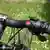 A red button on a bicycle handlebar