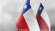 Small national flags of the Chile on a light blurry background.