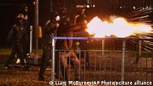 Youths fire fireworks at the PSNI on the Springfield road, during further unrest in Belfast, Northern Ireland, Thursday, April 8, 2021. Police and politicians in Northern Ireland have appealed for calm after a third night of violence that saw Protestant youths start fires and pelt officers with bricks and gasoline bombs. The flareups come amid rising tensions over post-Brexit trade rules for Northern Ireland and worsening relations between the parties in the Protestant-Catholic power-sharing Belfast government. (Liam McBurney/PA via AP)