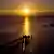 A pier stretches out into the Baltic Sea as the sun rises