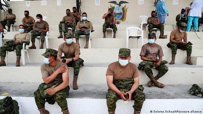 Soldiers rest after getting shots of the AstraZeneca COVID-19 vaccine at the Epiclachima Military Fort in Quito, Ecuador