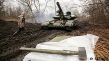 Ukrainian servicemen work on their tank close to the front line with Russian-backed separatists near Lysychansk, Lugansk region on April 7, 2021. - Ukrainian President Volodymyr Zelensky has urged NATO to speed up his country's membership into the alliance, saying it was the only way to end fighting with pro-Russia separatists. (Photo by STR / AFP)