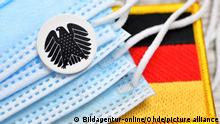 Deutscher Bundesadler, Schutzmasken und deutsche Fahne, Symbolfoto Nationale Gesundheitsreserve