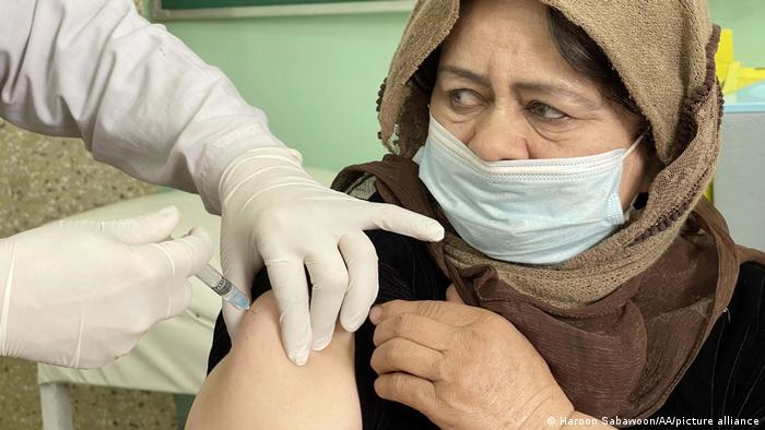 Afghan woman getting vaccinated