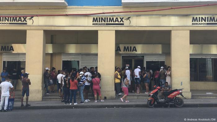 A group of Cubans waiting in line at a supermarket in Havana