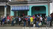 People wearing face masks as a precautionary measure against the spread of the novel coronavirus, COVID-19, queue to buy food in Havana on March 22, 2021. - The Cuban economy is at its worst moment in almost 30 years, falling 11% in 2020, the biggest drop since 1993. The Communist Party Congress in April 2021, which marks Raul Castro's departure from power, will have to push for greater openness to private enterprise for the country to take off. (Photo by Yamil LAGE / AFP) (Photo by YAMIL LAGE/AFP via Getty Images)