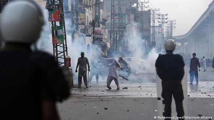Pakistani TLP demonstrators throw stones at police. 
