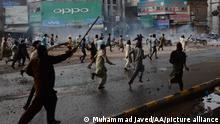 LAHORE, PAKISTAN - APRIL 12: Pakistani Islamists of Tehreek-e-Labbaik Pakistan (TLP) run away as police use teargas and water cannon against them during a protest in Lahore, on April 12, 2021. Pakistan police used tear gas and water cannon Monday on thousands of supporters of an Islamist anti-blasphemy party of Tehreek-e-Labbaik Pakistan (TLP), after the arrest of their leader Saad Rizvi, who has called for the expulsion of the French ambassador. Anti-French sentiment has been simmering for months in Pakistan since the government of President Emmanuel Macron expressed support for a magazine's right to republish cartoons depicting Prophet Mohammed -- deemed blasphemous by many Muslims. Muhammad Javed / Anadolu Agency