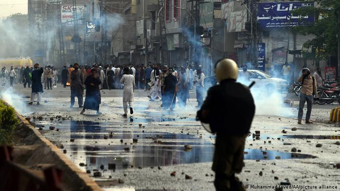 Pakistani police use teargas and water cannon against anti-France Islamist protesters during a protest in Lahore