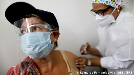 An elderly woman receives a dose of Russia's Sputnik V coronavirus disease (COVID-19) vaccine in Caracas