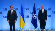 NATO Secretary General Jens Stoltenberg, right, and Ukraine's Foreign Minister Dmytro Kuleba pose for photographers prior to a meeting at NATO headquarters in Brussels, Tuesday, April 13, 2021. (AP Photo/Francisco Seco, Pool)