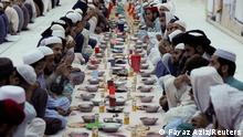 People pray before Iftar (breaking fast) during the fasting month of Ramadan, as the outbreak of the coronavirus disease (COVID-19) continues, at a mosque in Peshawar, Pakistan April 14, 2021. REUTERS/Fayaz Aziz