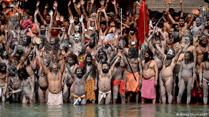 Naga Sadhus (Hindu holy men) take a holy dip in the waters of the Ganges river