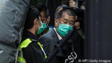 TOPSHOT - Media tycoon Jimmy Lai (R) is escorted into a Hong Kong Correctional Services van outside the Court of Final Appeal in Hong Kong on February 1, 2021, after being ordered to remain in jail while judges consider his fresh bail application, the first major legal challenge to a sweeping national security law Beijing imposed on the city last year. (Photo by STR / AFP) (Photo by STR/AFP via Getty Images)