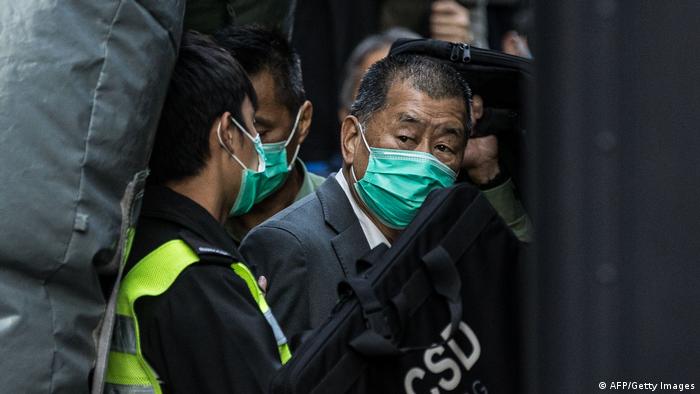  Media tycoon Jimmy Lai (right) is escorted into a Hong Kong Correctional Services van outside the Court of Final Appeal in Hong Kong on February 1, 2021.