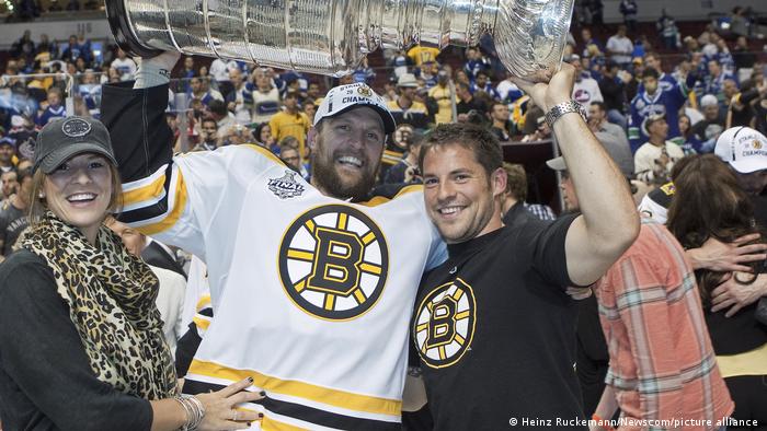 Boston Bruins defender Dennis Seidenberg lifts the Stanley Cup
