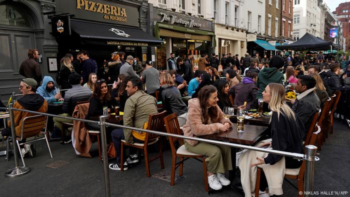 Festive atmosphere on Old Compton Street in London with people dining outdoors