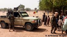 Soldiers of the Chad Army stand next to a Land Cruiser, while bystanders look on, before buing sheep at the Koundoul market, 25 km from N'Djamena, on January 3, 2020, upon their return after a months-long mission fighting Boko Haram in neighbouring Nigeria. - Chad has ended a months-long mission fighting Boko Haram in neighbouring Nigeria and withdrawn its 1,200-strong force across their common border, an army spokesman told AFP on January 4, 2020. (Photo by - / AFP) (Photo by -/AFP via Getty Images)