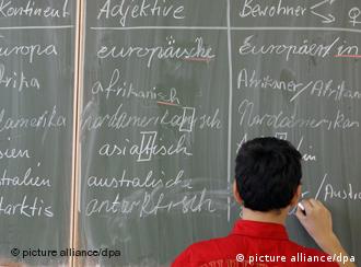 Boy writing on blackboard