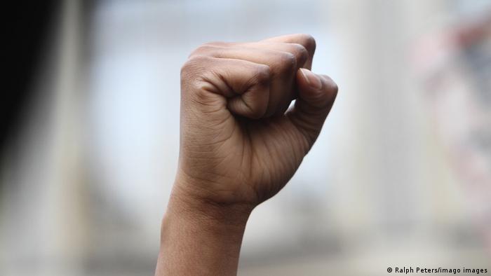 A person holding up their fist in protest during an anti-racism demonstration in Frankfurt, Germany