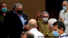(FILES) In this file photo released by Cuban News Agency ACN taken on October 28, 2020 former Cuban President Raul Castro (C) waves next to Cuban President Miguel Diaz-Canel (L) during the annual session of the Cuban Parliament at the Convention Palace in Havana, amid the new coronavirus pandemic. - Raul Castro, who was for decades in the shadow of his brother Fidel, retires in 2021 at 89 as a pragmatic leader who launched unprecedented economic reforms in Cuba, but who leaves without finishing them and without yielding to the principle of an only party. On the other hand, president and now first secretary of the Communist Party Miguel Diaz-Canel, who was born after the victory of the 1959 revolution, embodies the new generation in power in Cuba, more connected but not necessarily more flexible. (Photo by Ariel LEY / ACN / AFP) / RESTRICTED TO EDITORIAL USE - MANDATORY CREDIT AFP PHOTO / ACN / ARIEL LEY - NO MARKETING NO ADVERTISING CAMPAIGNS -DISTRIBUTED AS A SERVICE TO CLIENTS
