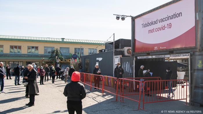 People are waiting outside a nightclub that has been turned into a mass vaccination center in Stockholm, Sweden