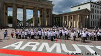 Demonstraters gather behind a red line at Berlin's Brandenburg Gate
